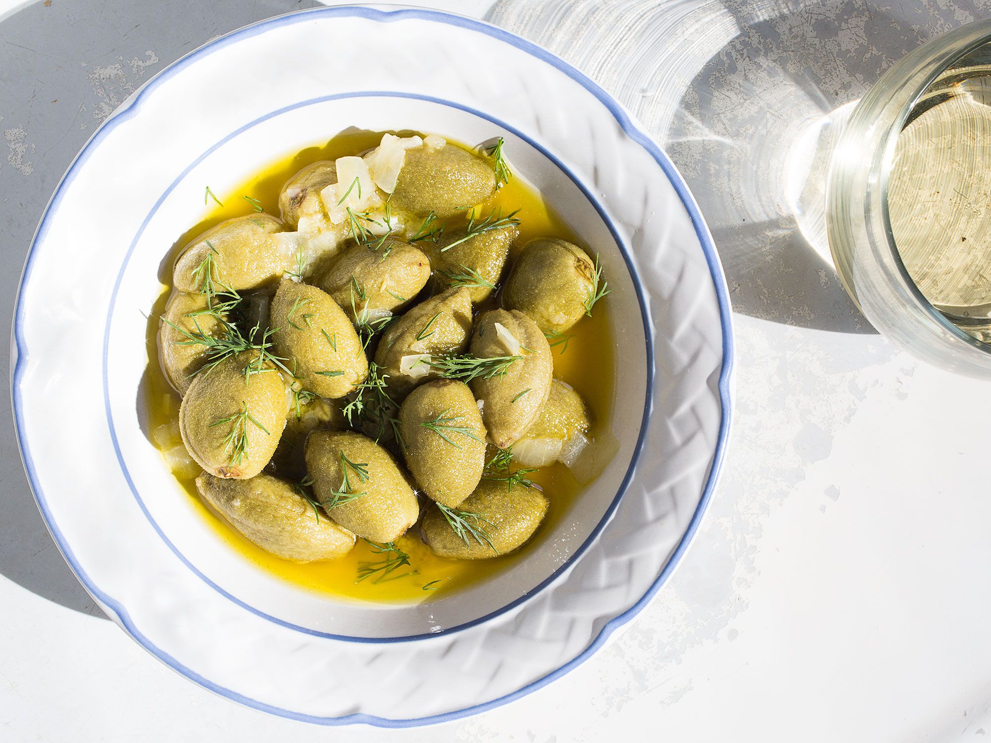 Green almonds are a rare spring treat; simmering them in olive oil, orange juice, and aromatics mitigates their slightly bitter exterior, making them an irresistible cocktail party snack. Get the recipe for <a href="https://www.saveur.com/olive-oil-poached-green-almonds-dill/">Olive-Oil Poached Green Almonds with Dill</a>