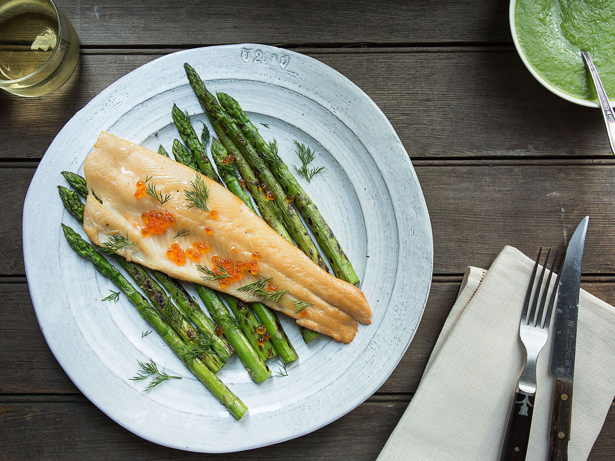 The char of grilled asparagus and the zest of fresh dill blend to make a distinctive, lively, spring-time sauce for stove-top smoked trout. Get the recipe for <a href="https://www.saveur.com/article/recipes/smoked-trout-with-grilled-asparagus-dill-sauce/">Smoked Trout with Grilled Asparagus-Dill Sauce</a>