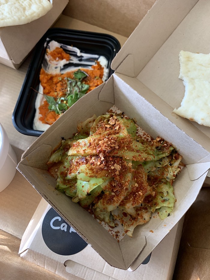 Grilled cabbage with kimchi salt and orange sriracha sauce.