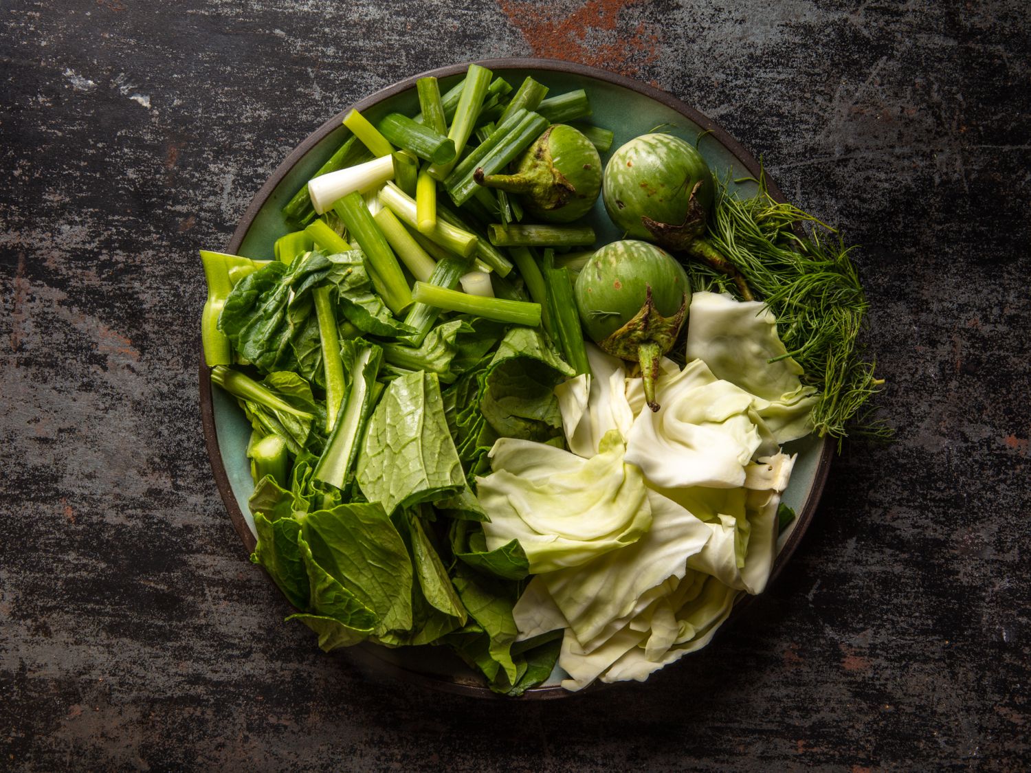 a plate of vegetables to use in Gaeng Om Gai (Isan-Style Herbal Curry with Chicken and Dill)