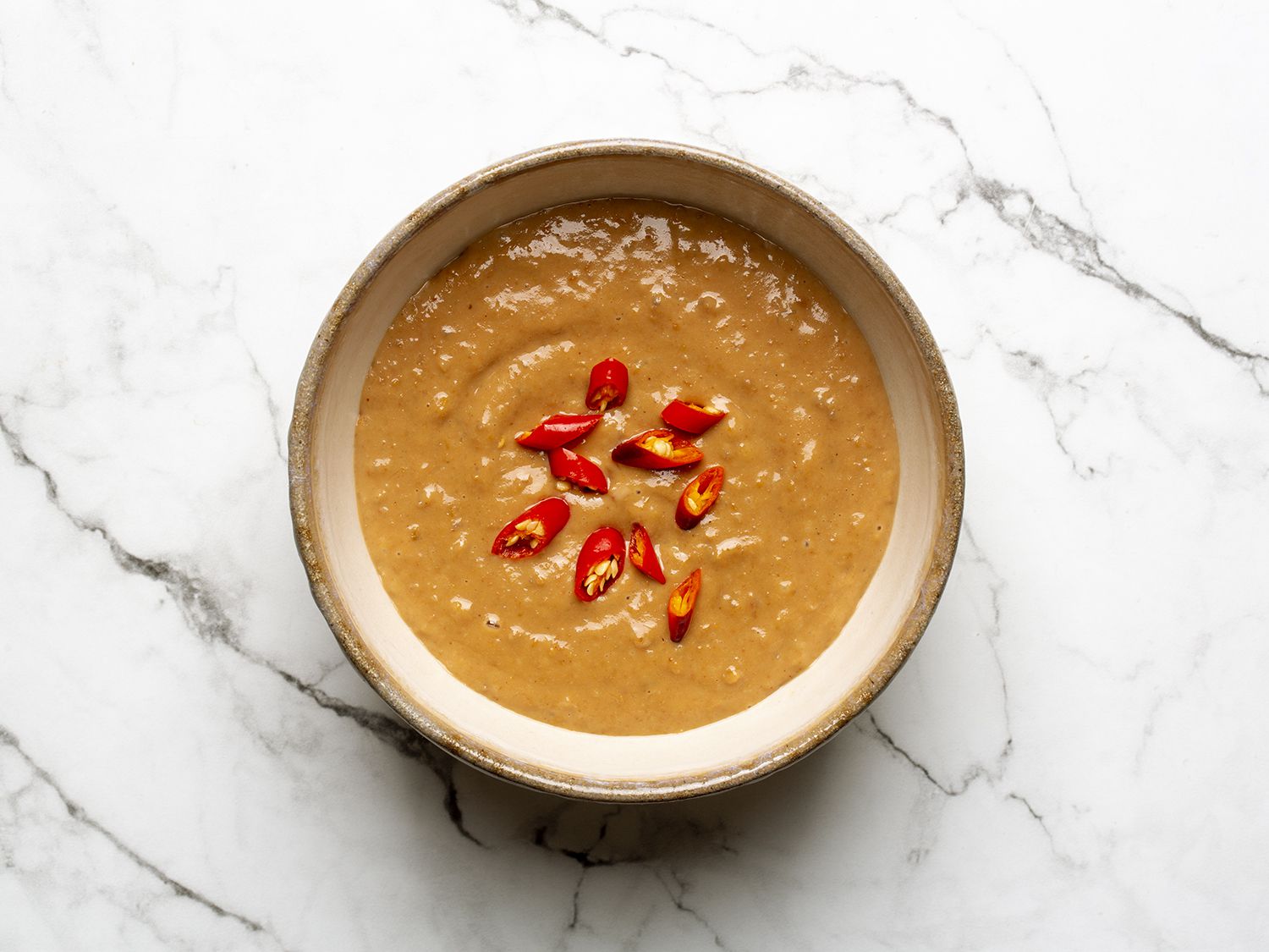 Pork peanut dipping sauce garnished with red chiles