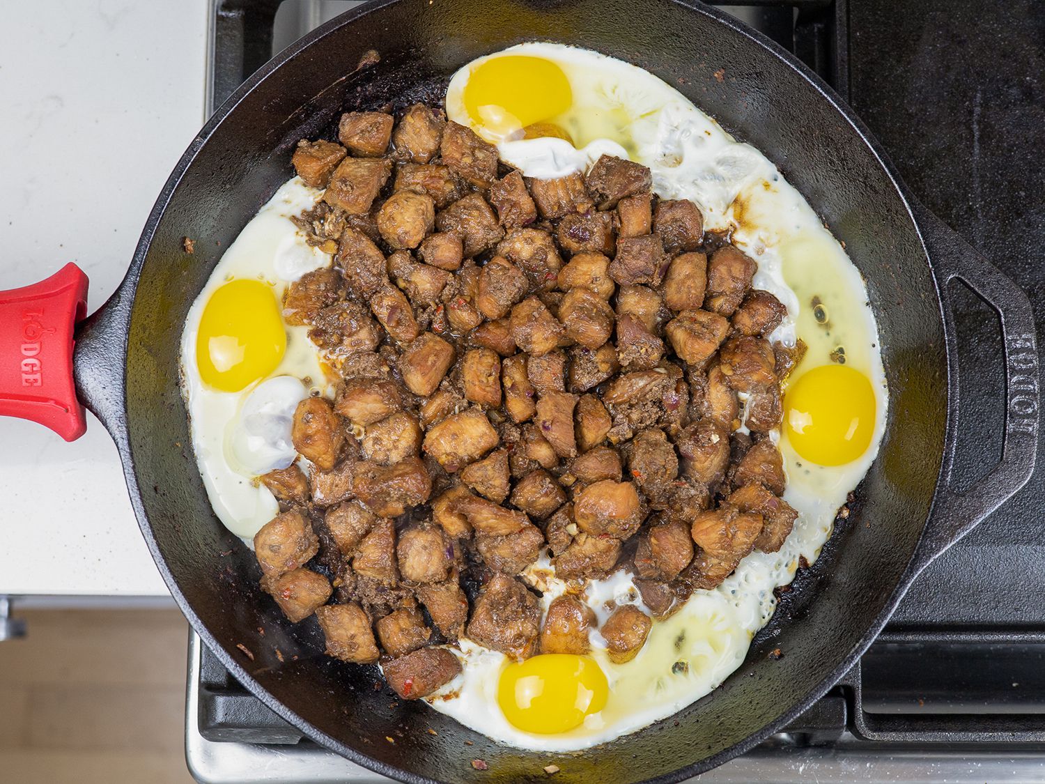 adding eggs to sisig