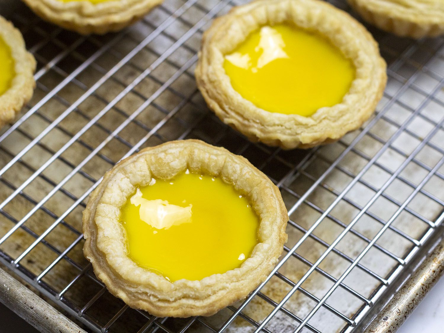 Hong Kong egg custard tarts on a cooling rack