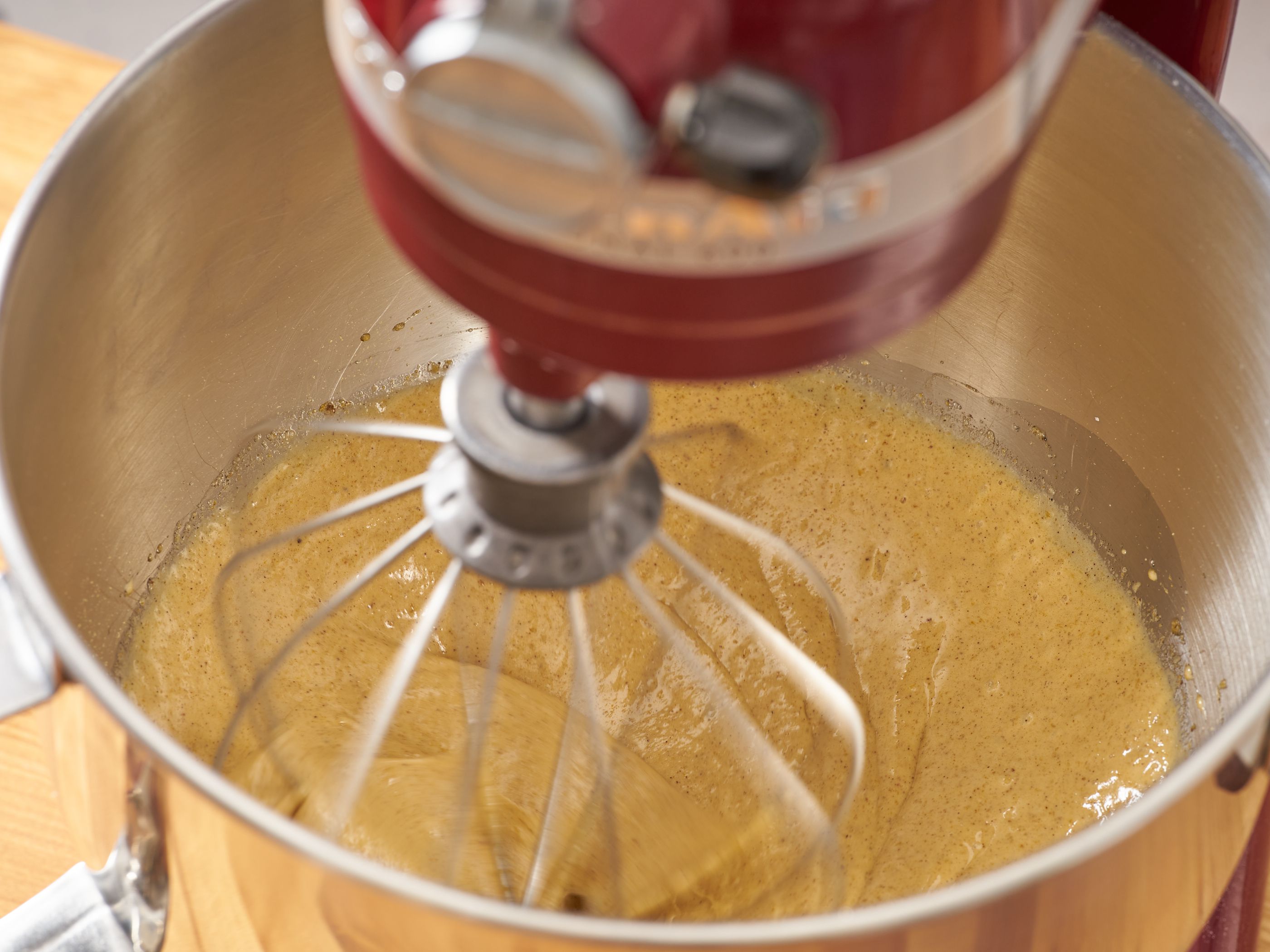 granulated sugar, muscovado sugar, eggs, vanilla, grated gingCoriander, allspice, nutmeg, instant espresso, cardamom, and clove being whisked in a stand mixer.