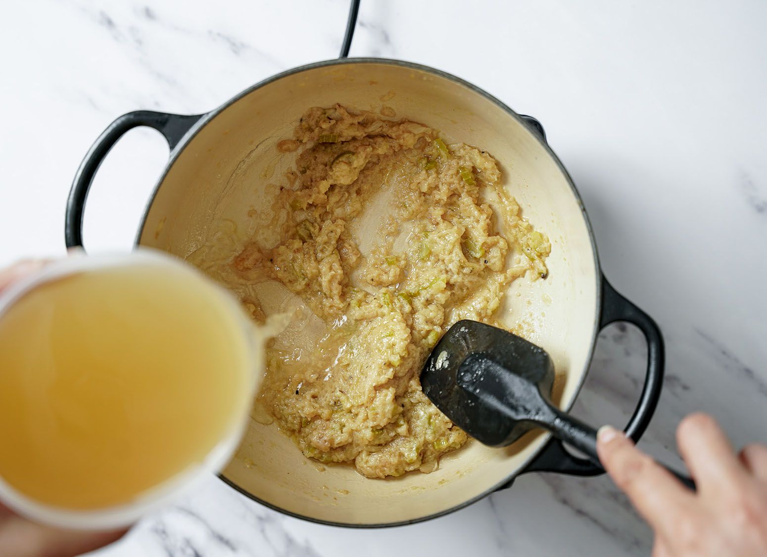 Stock being added to a roux.