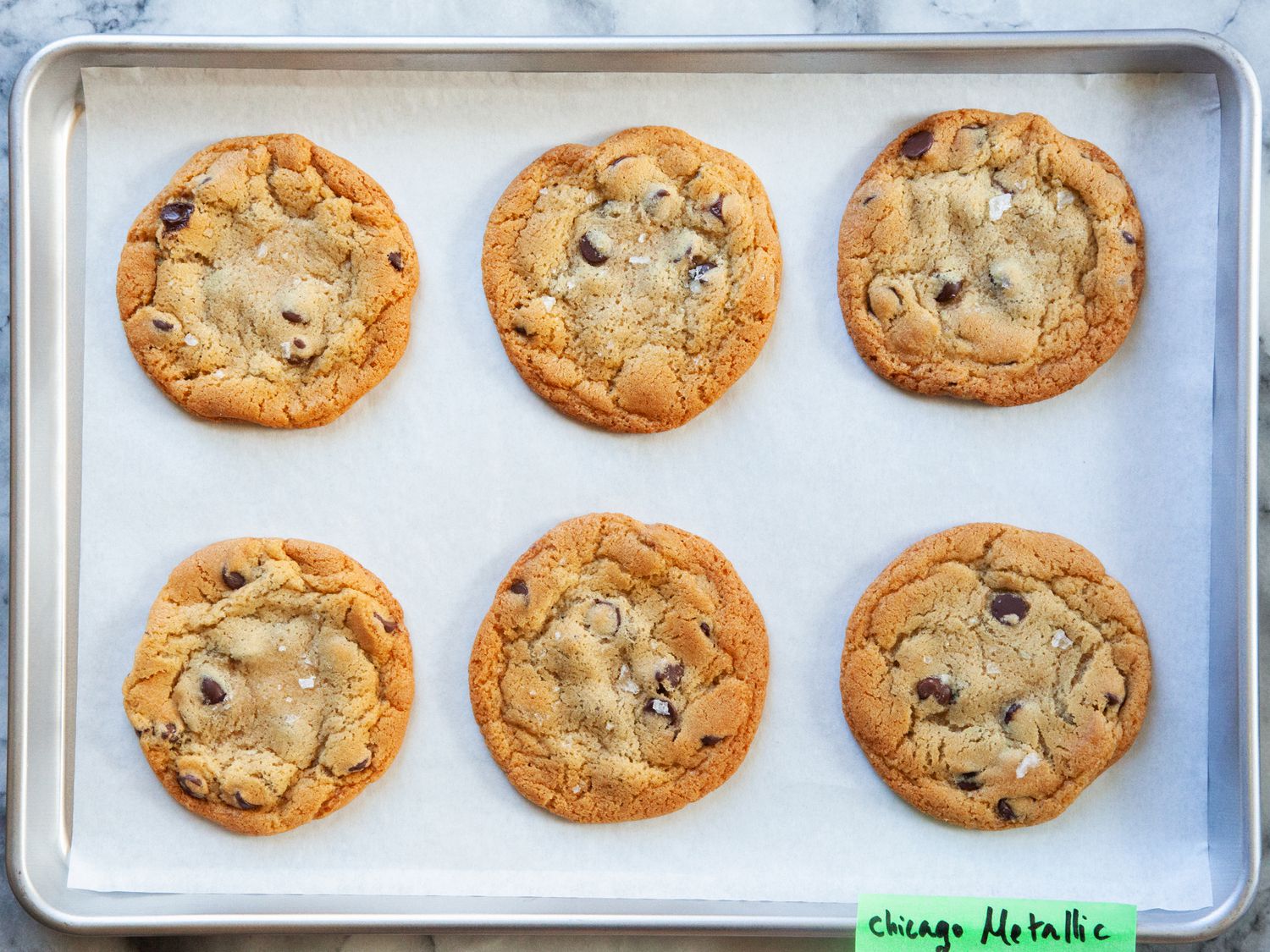 baked cookies on a piece of parchment paper on a sheet pan.