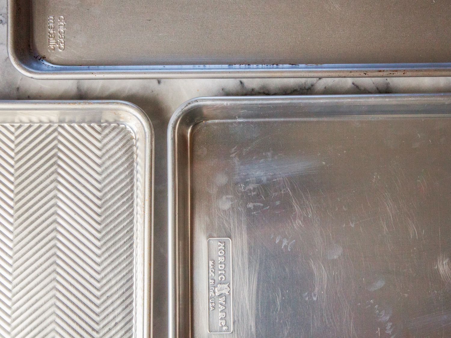 a closeup of a variety of pans and their different finishes: matte, shiny, and ridged.