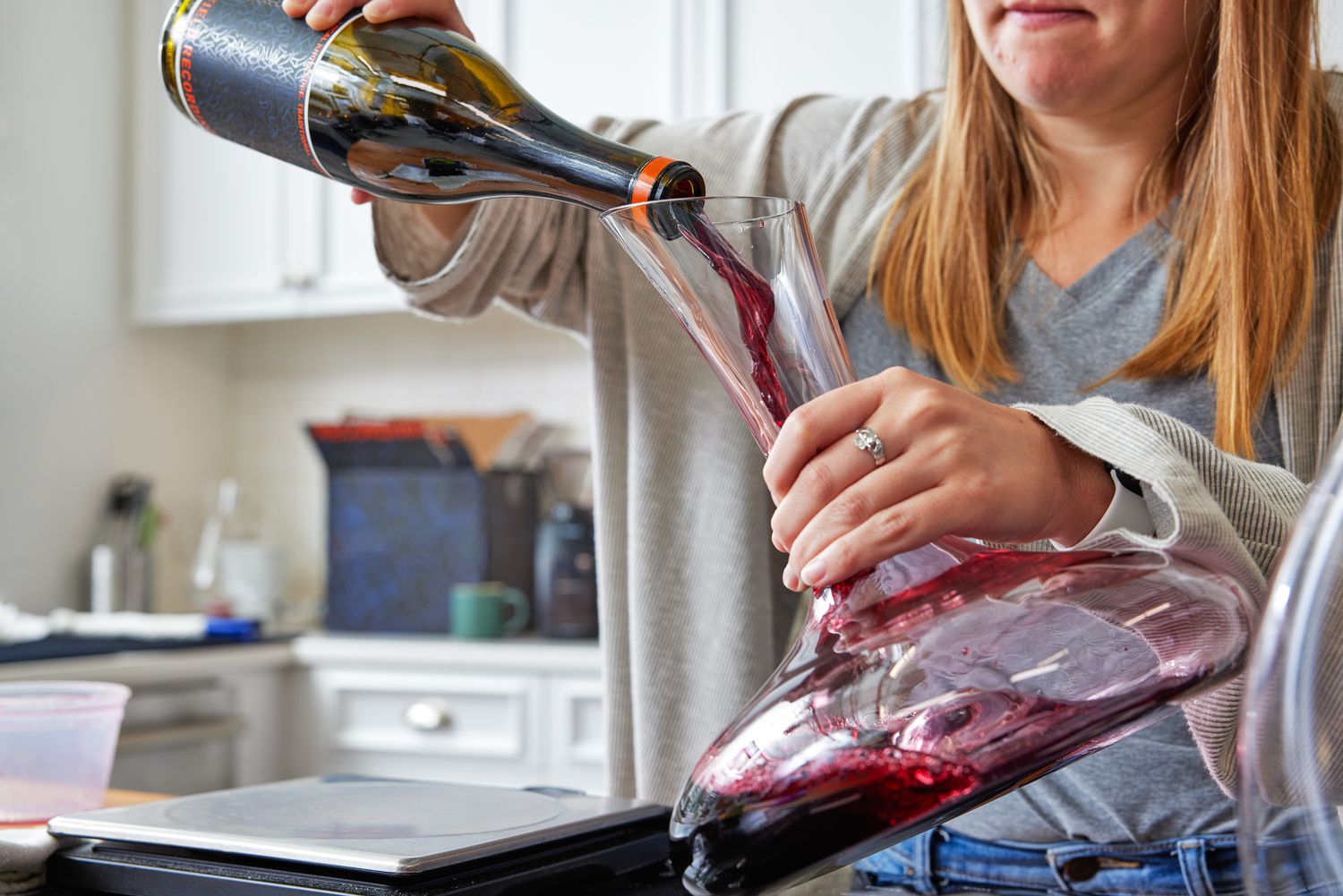 Red wine being decanted into a standard wine decanter held at an angle