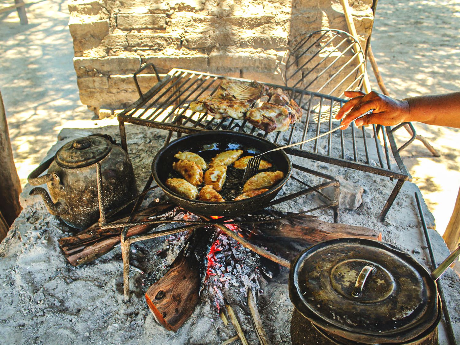 Graciela Cavana fries goat empanadas in her outdoor kitchen