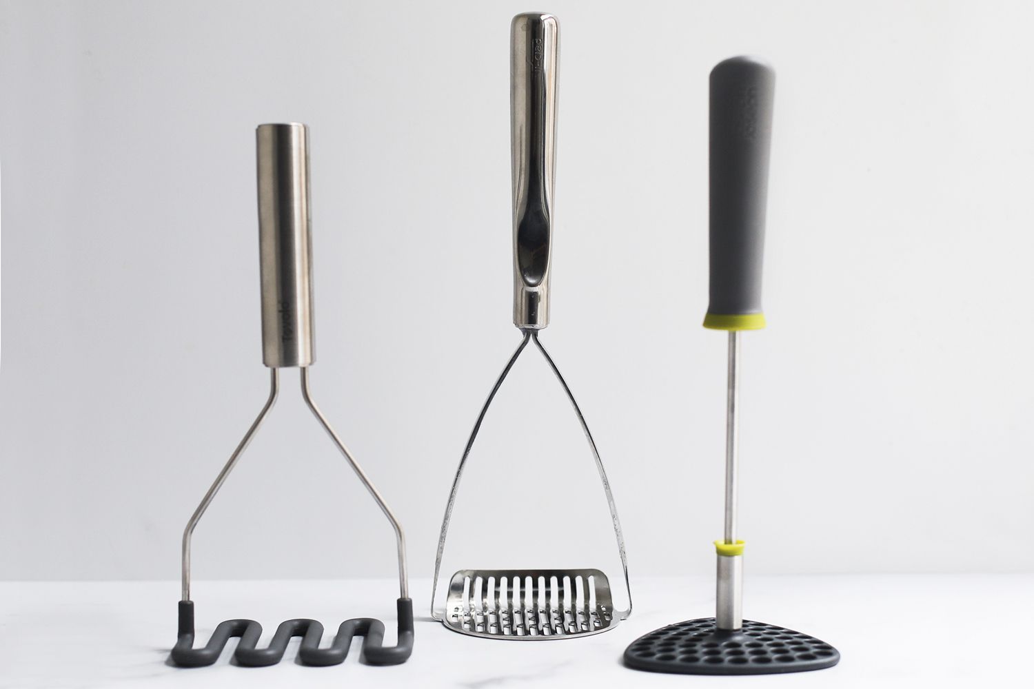 three mashers against a white background