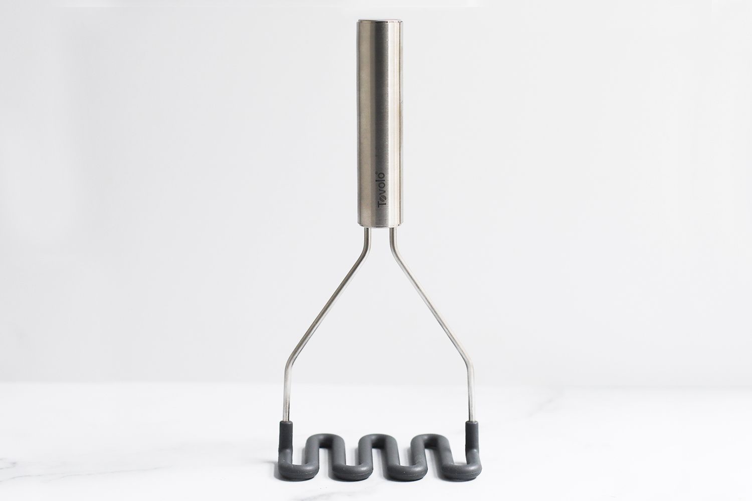 Tovolo potato masher against a white background