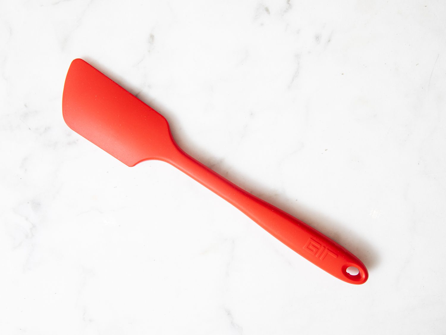 A read GIR silicone spatula on a marble surface