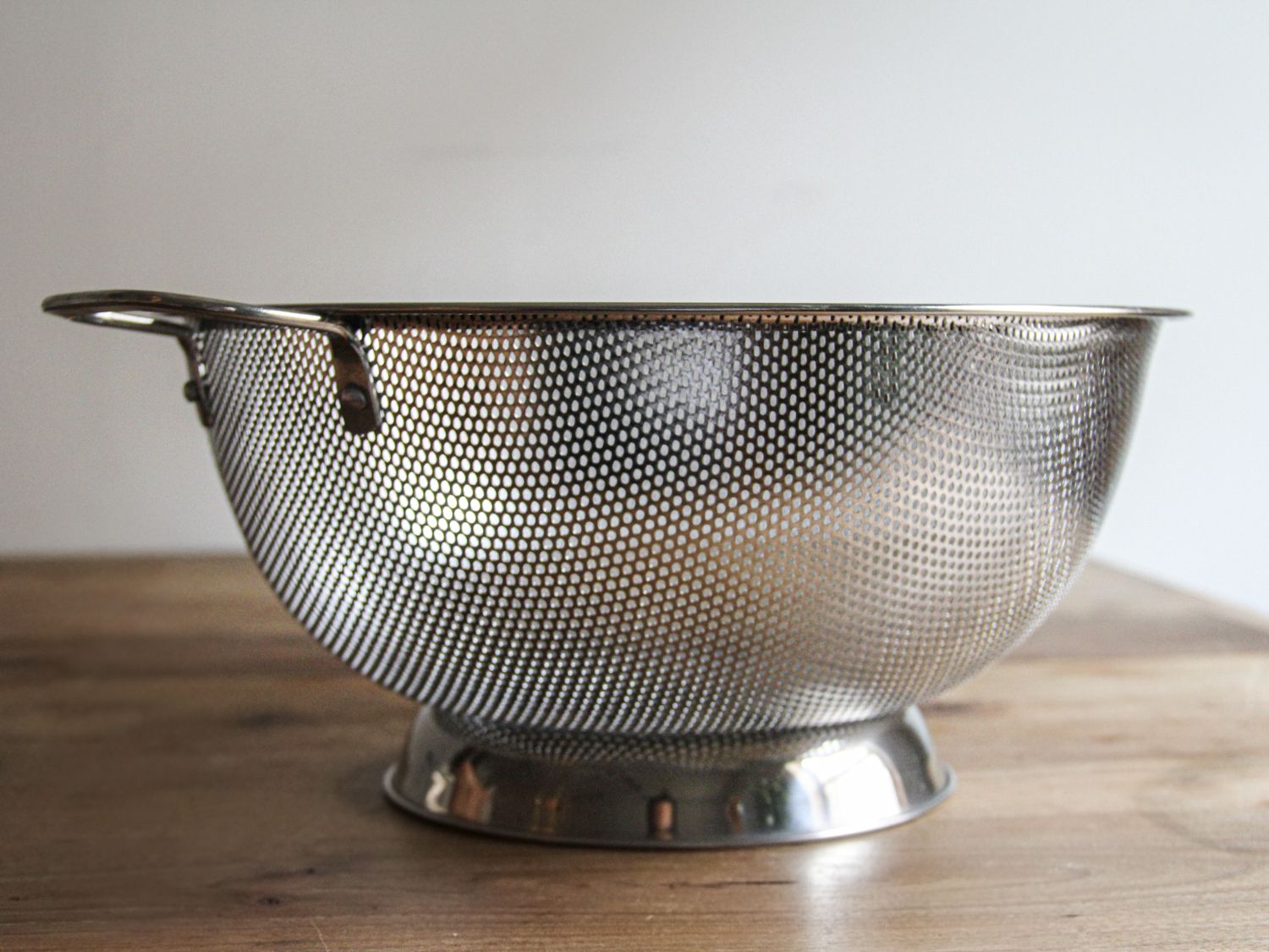 a closeup look at the RSVP colander sitting on a wooden surface