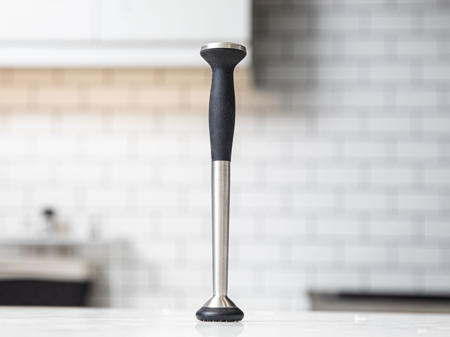 the OXO muddler on a marble kitchen countertop