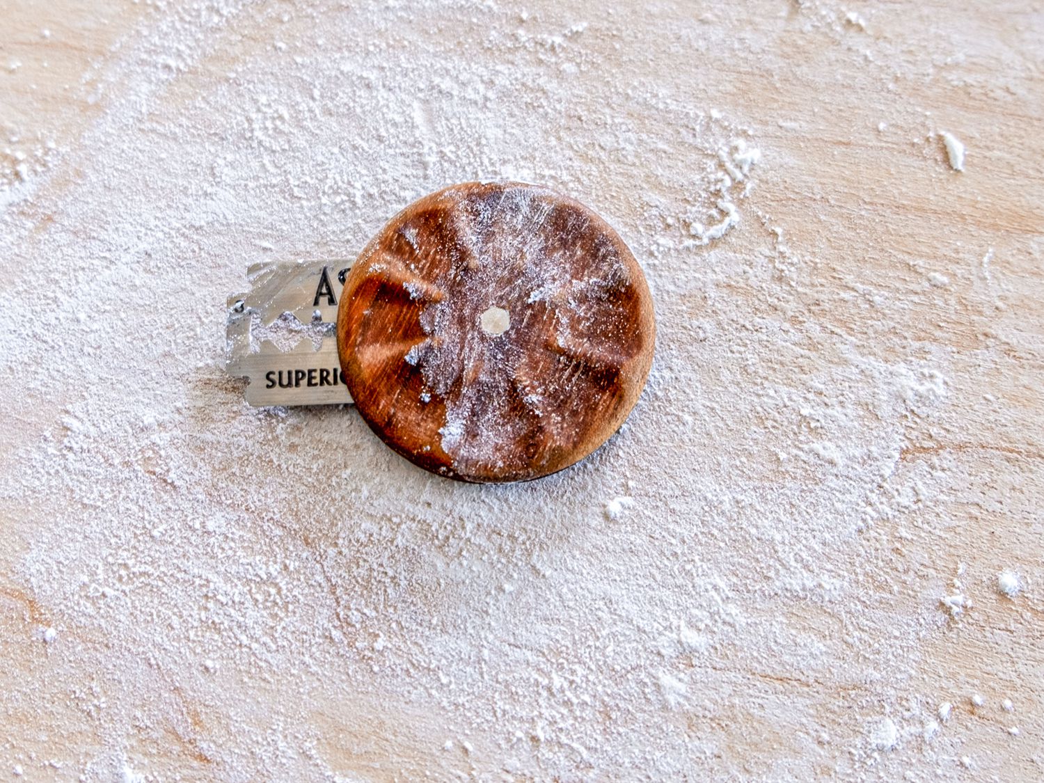 Wire monkey bread lame on a floured surface