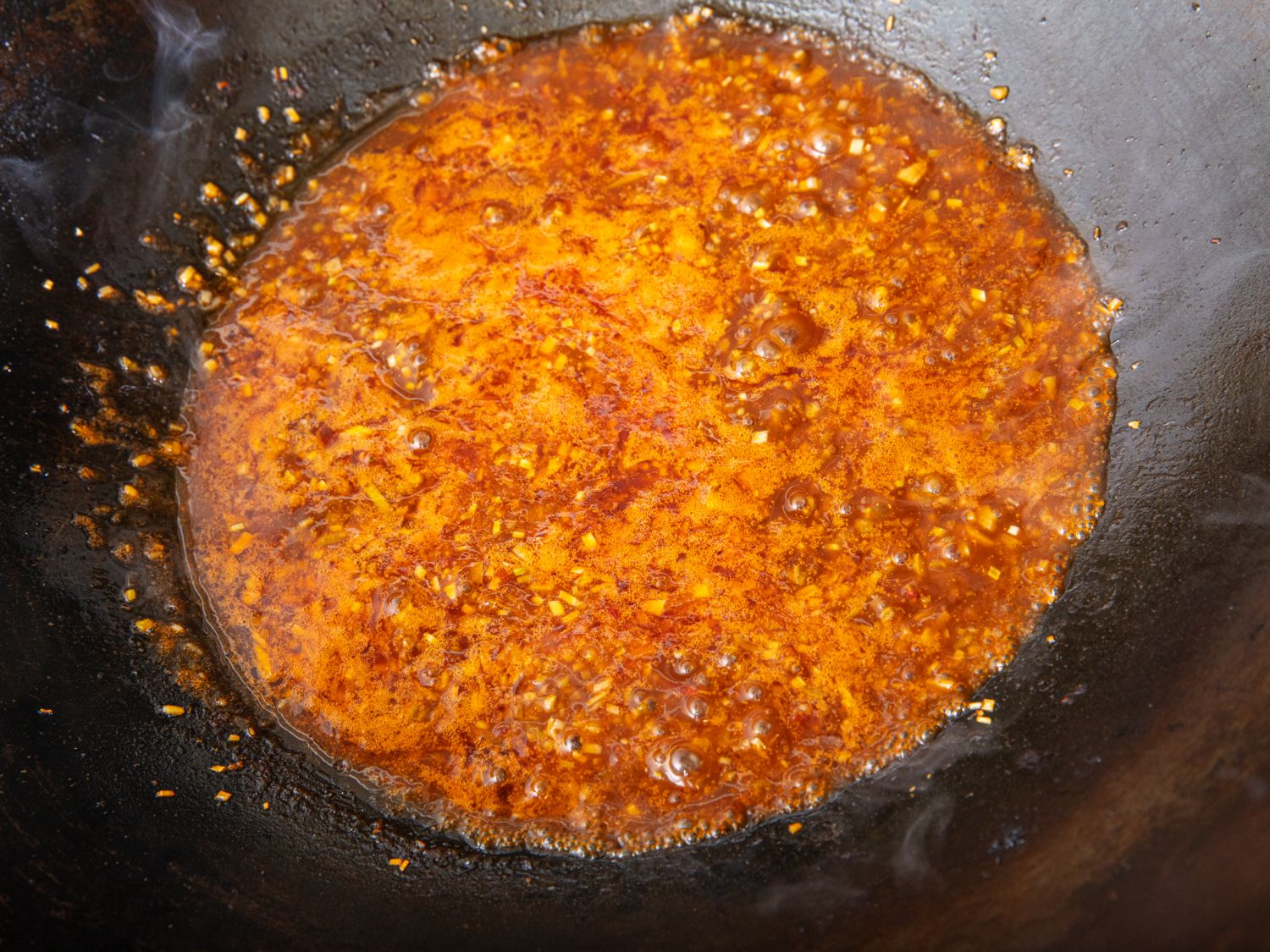 Sauce bubbling in a wok.