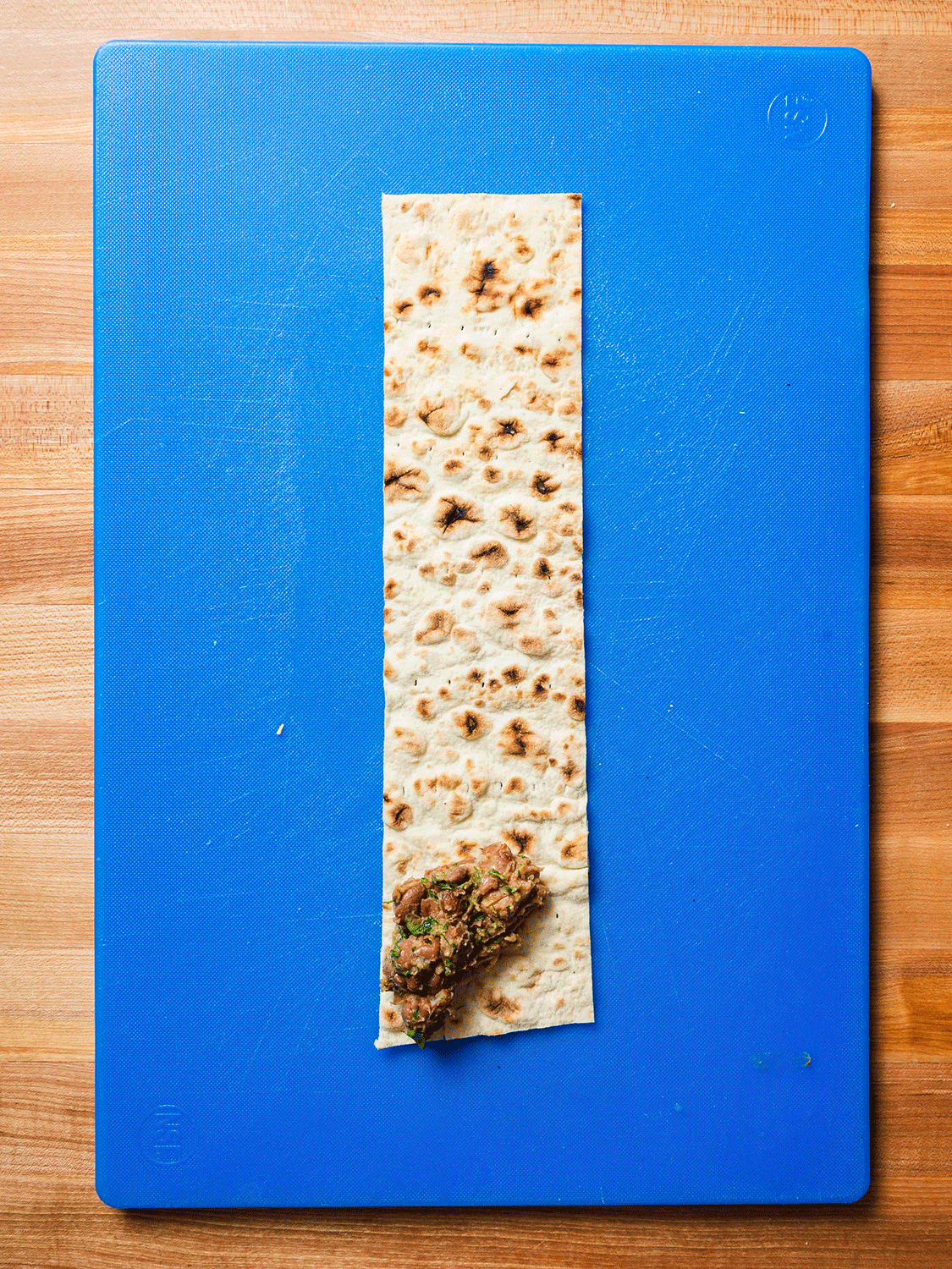 Rolling lavash strips.