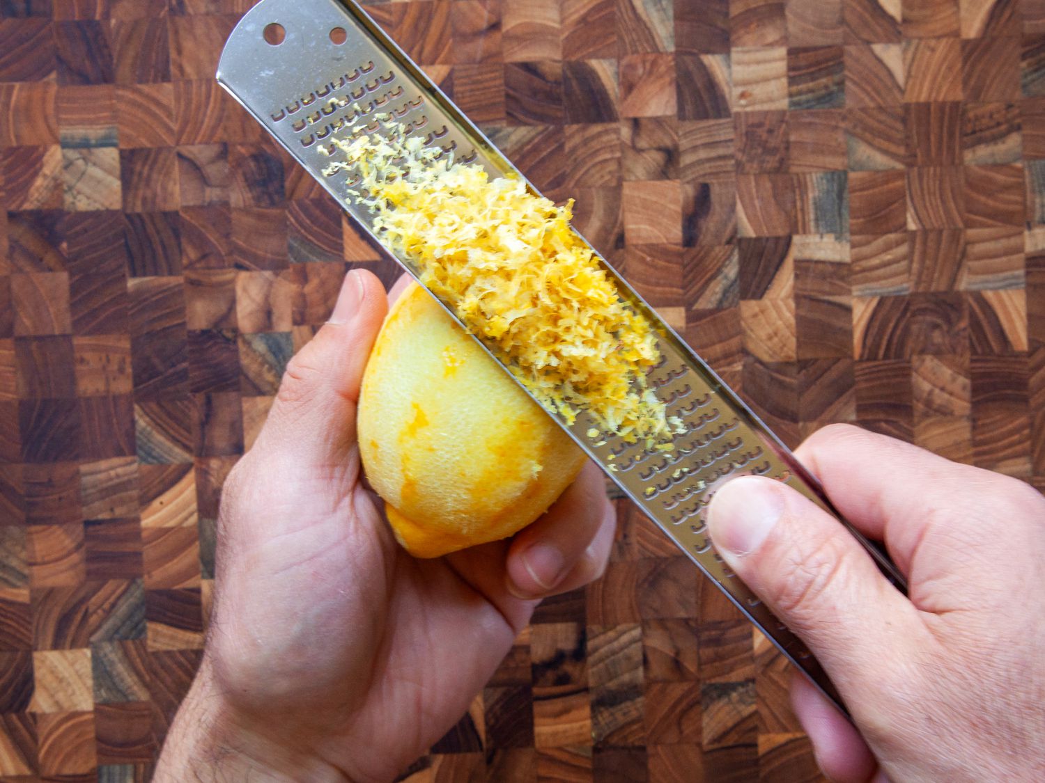 zesting a lemon with a stainless steel Microplane