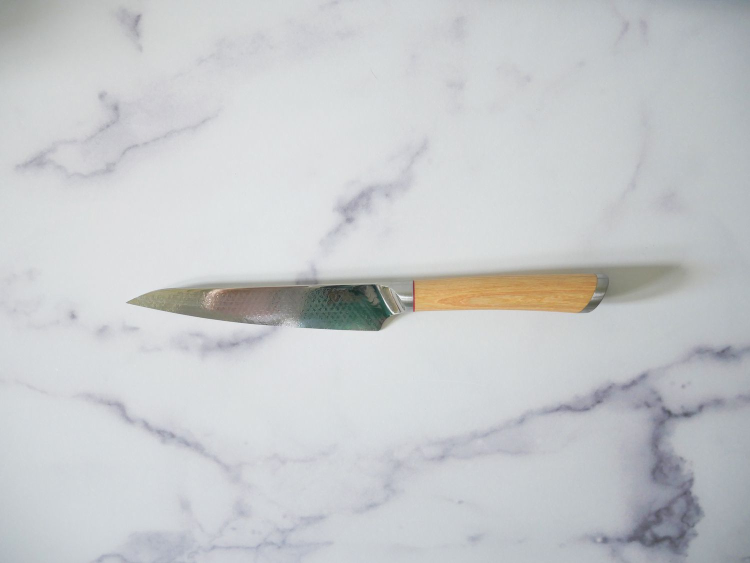 Shun petty knife on marble countertop