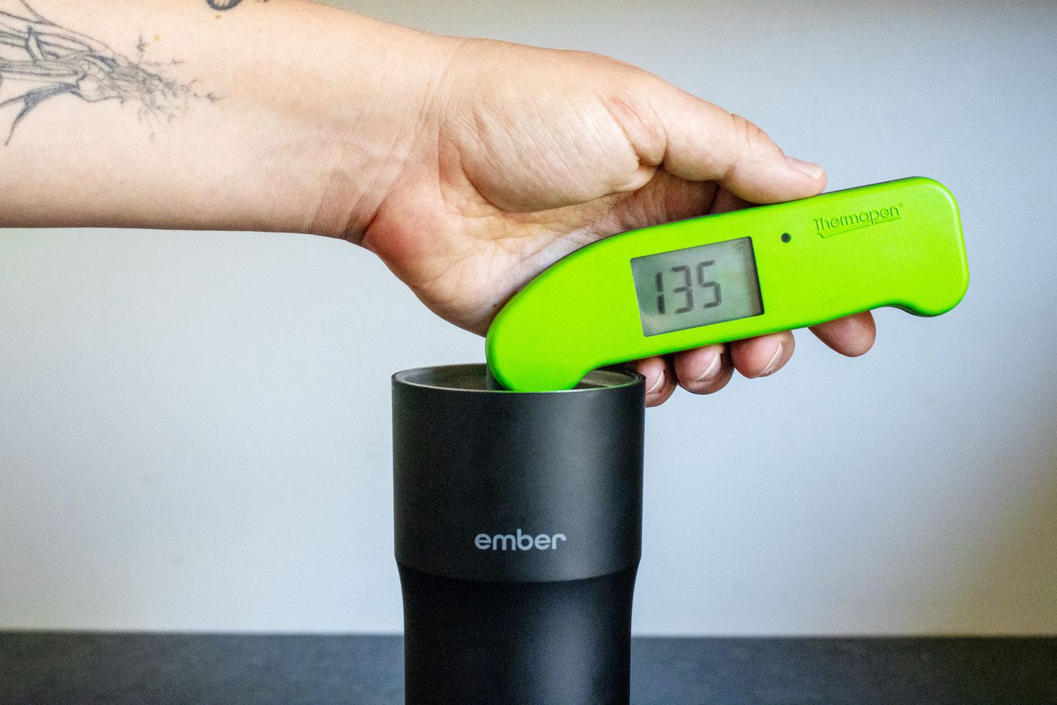 A Thermapen taking the temperature of coffee inside the Ember Travel Mug
