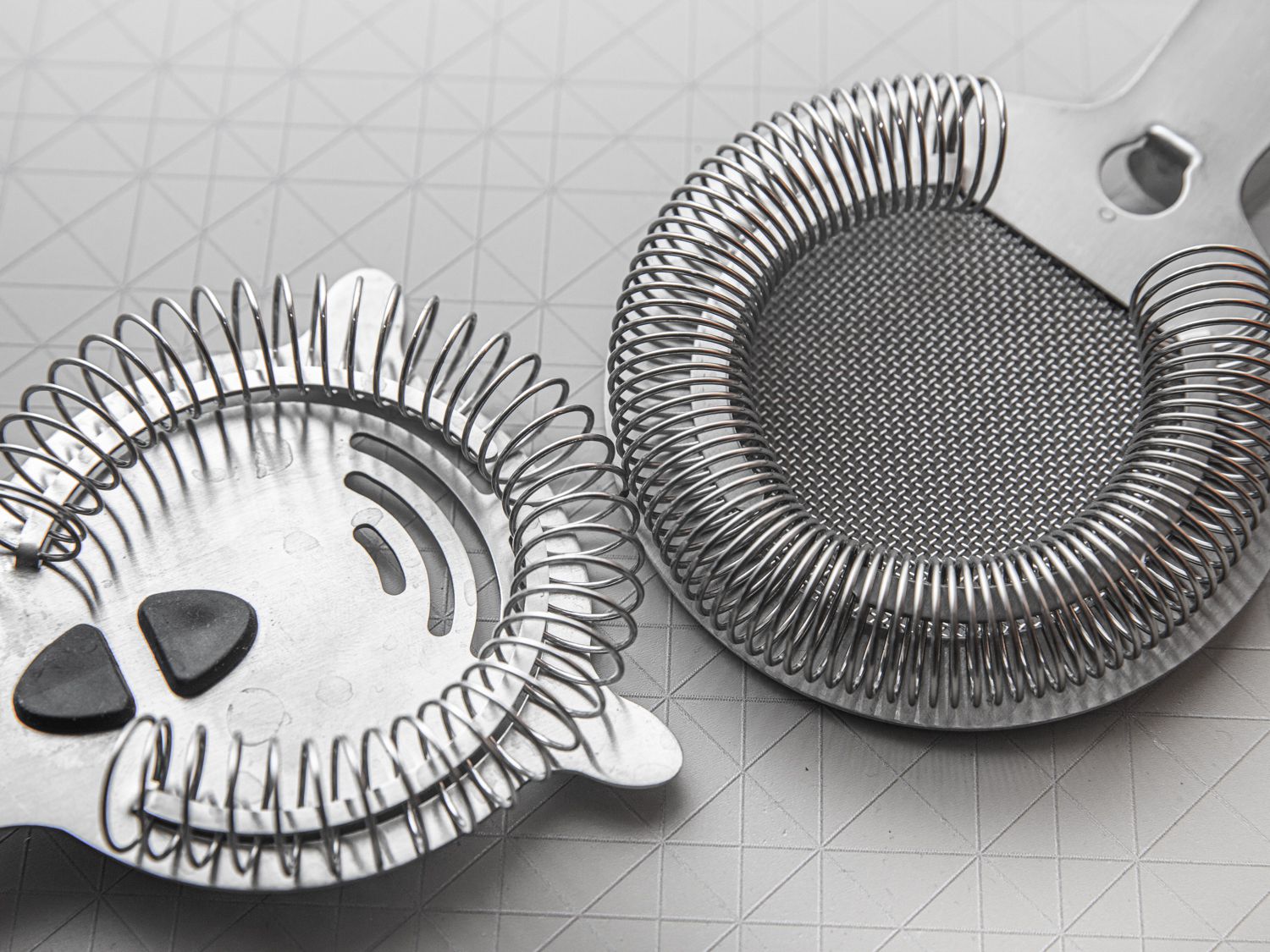 Two hawthorne strainers side-by-sideÃ¢ÂÂone with a looser spring and the other with a tight spring