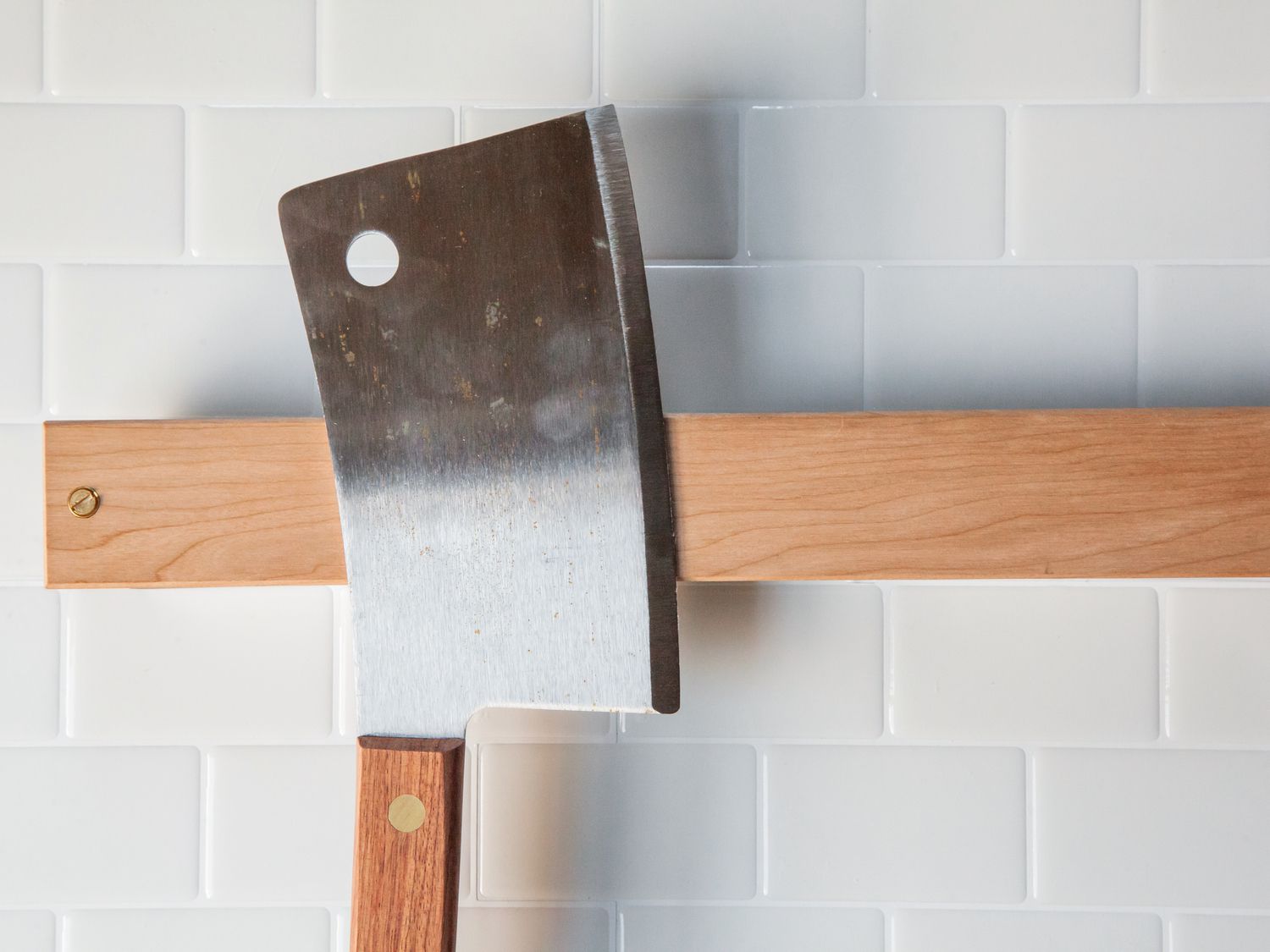 a cleaver on a pale magnetic knife holder