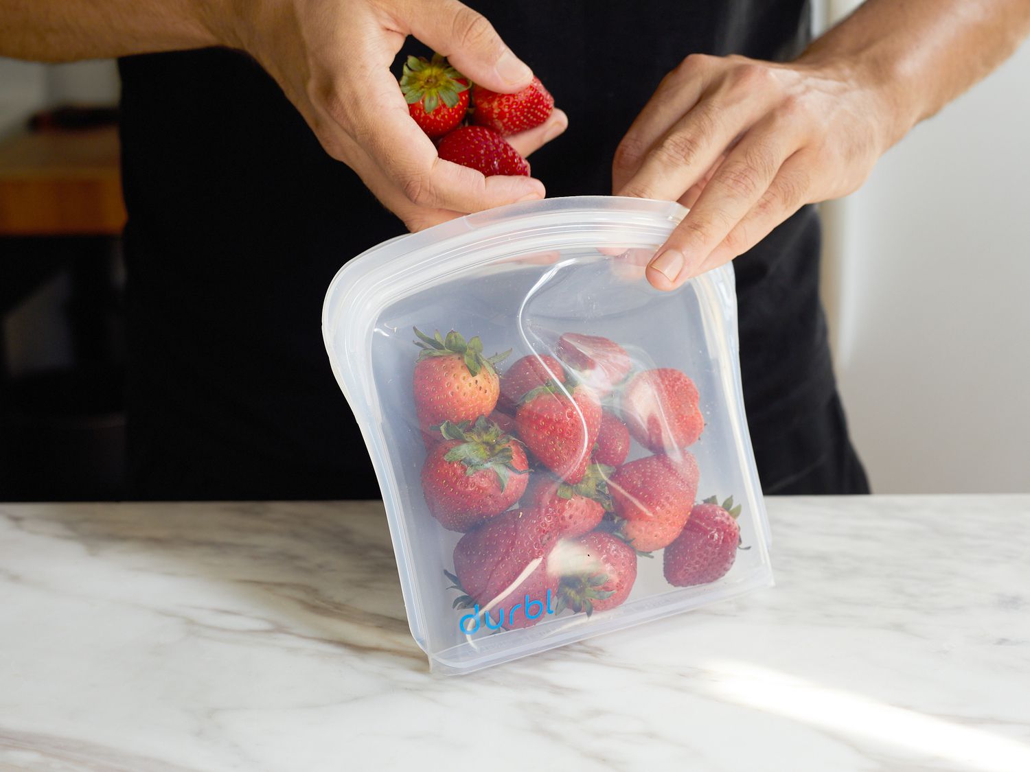 putting strawberries into a durbl bag
