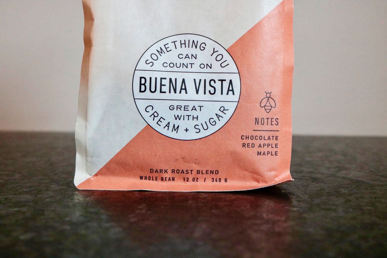 a look at an orange and white colored bag of coffee