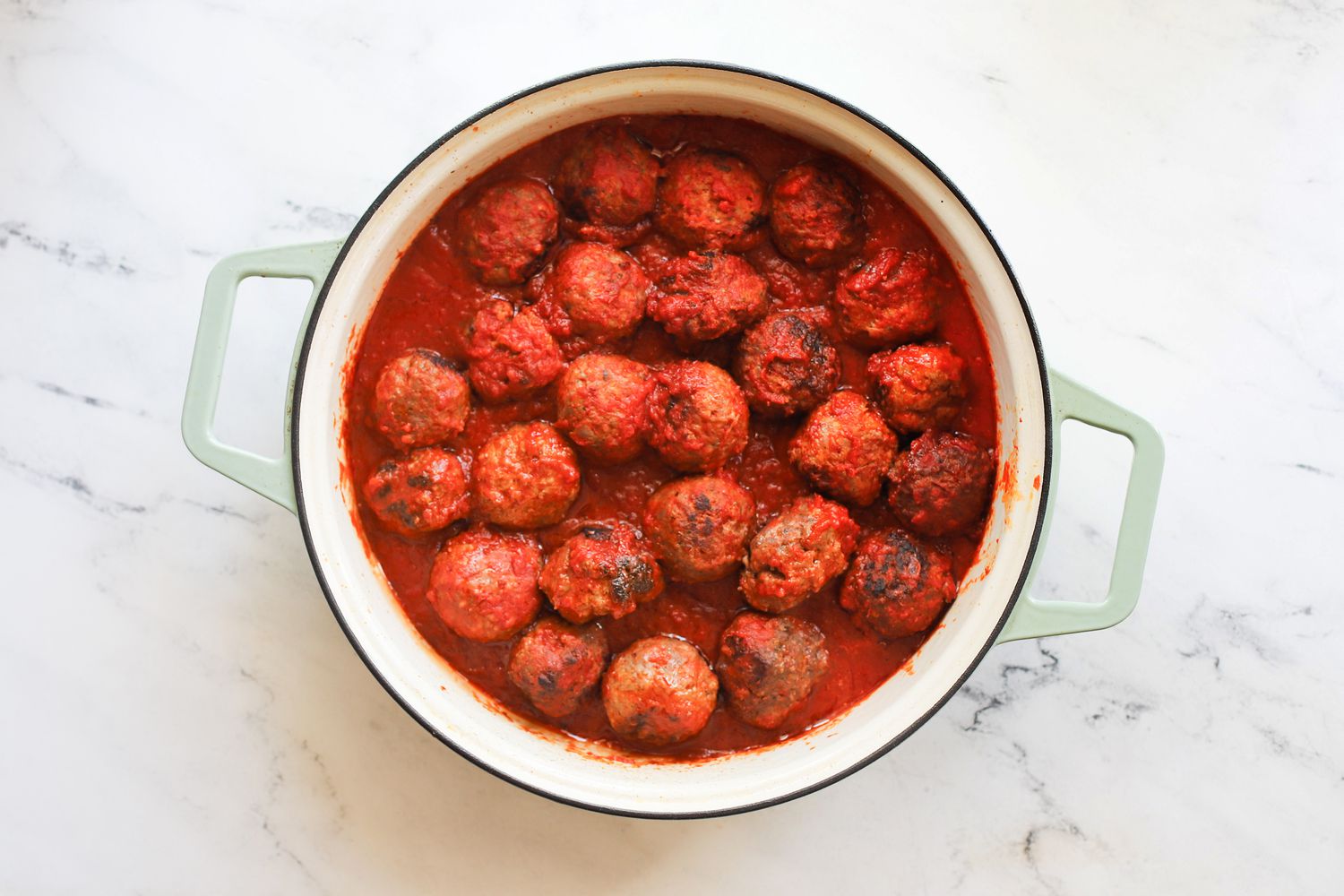 Cooked meatballs in tomato sauce in a braiser