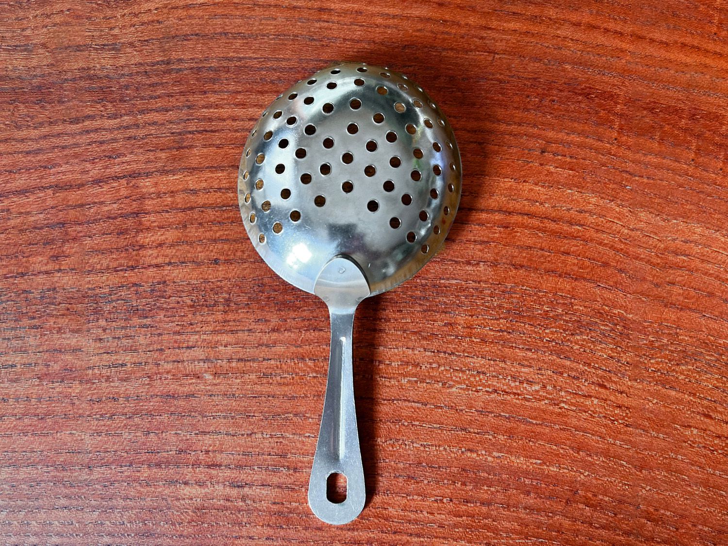 winco strainer on wooden surface