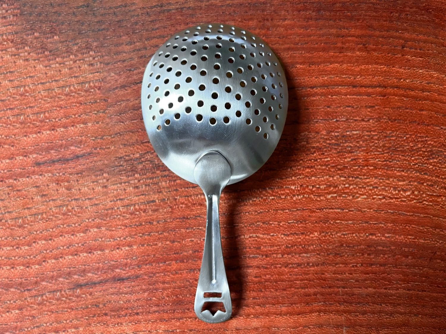 cocktail kingdom strainer on wooden surface
