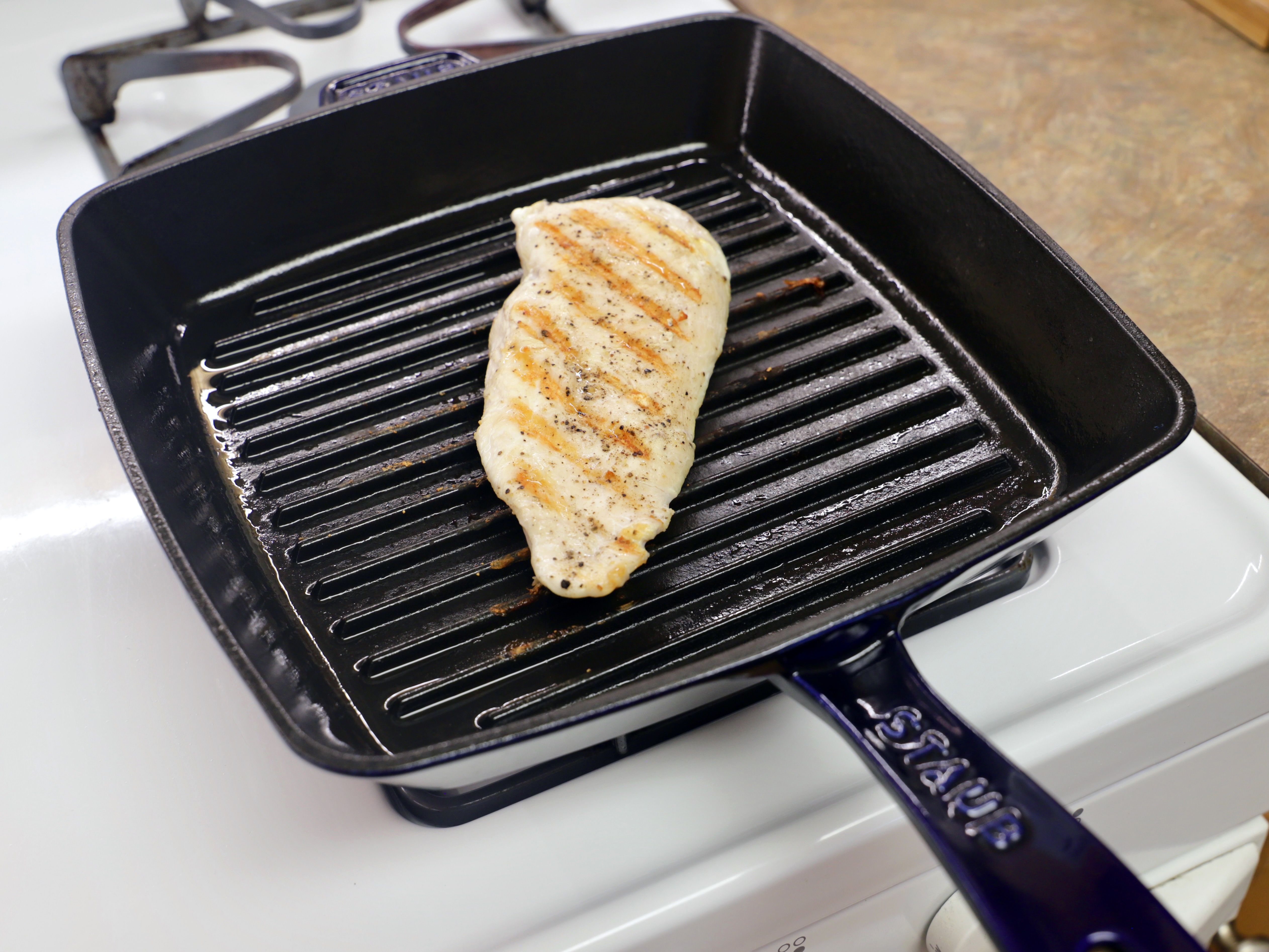 a piece of chicken breast in the staub grill pan
