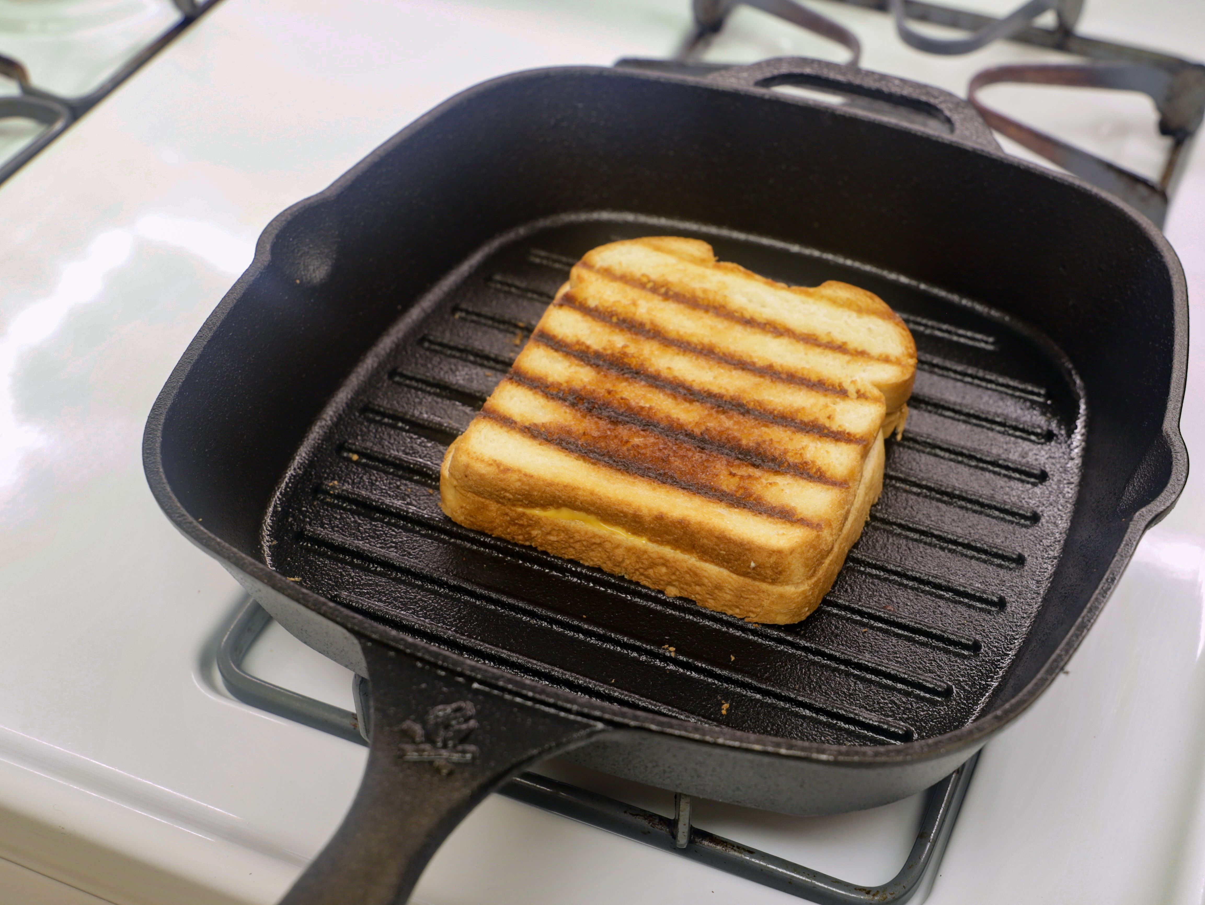 grilled cheese in a grill pan with char marks.