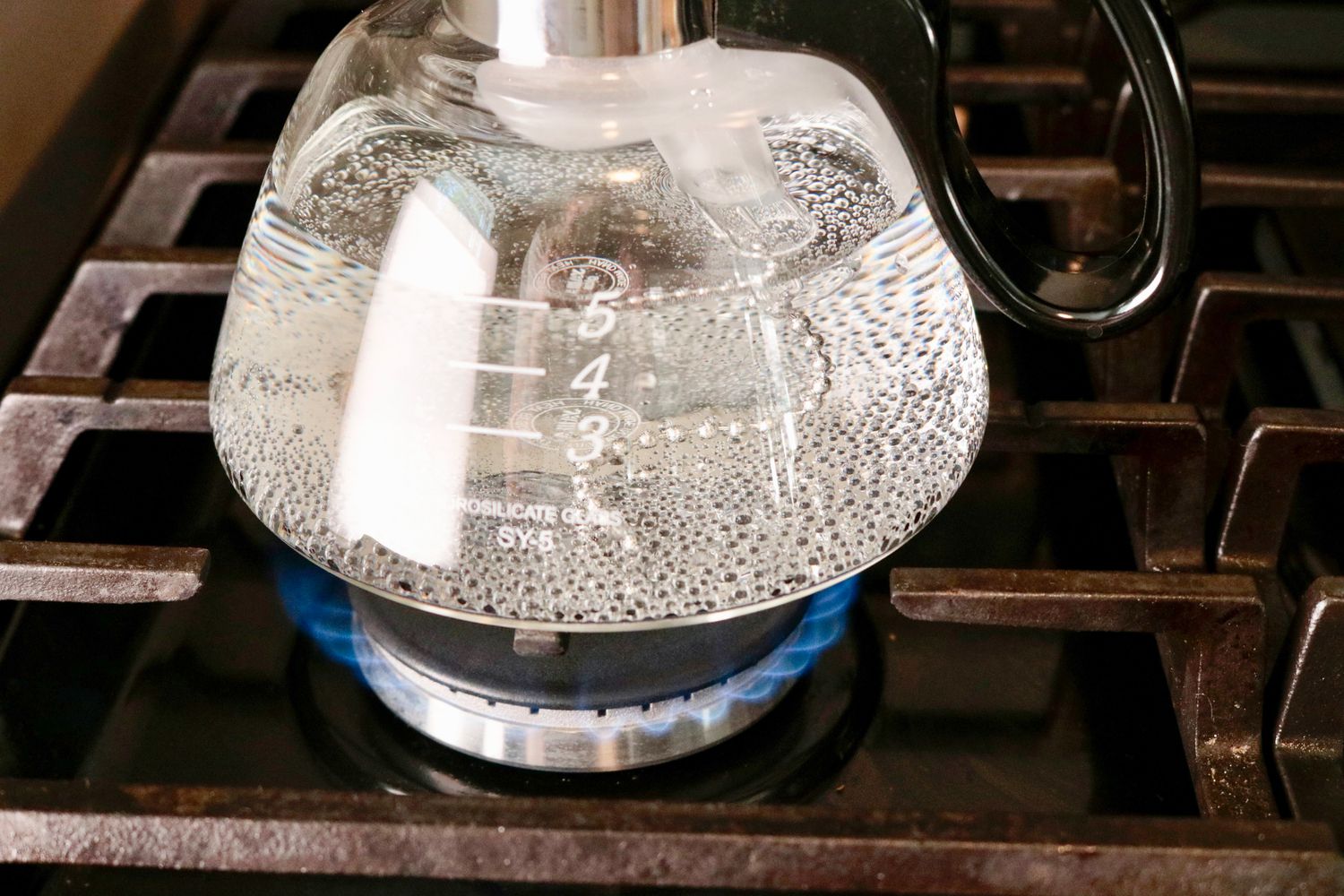 a closeup of water boiling in a glass coffee brewer's chamber