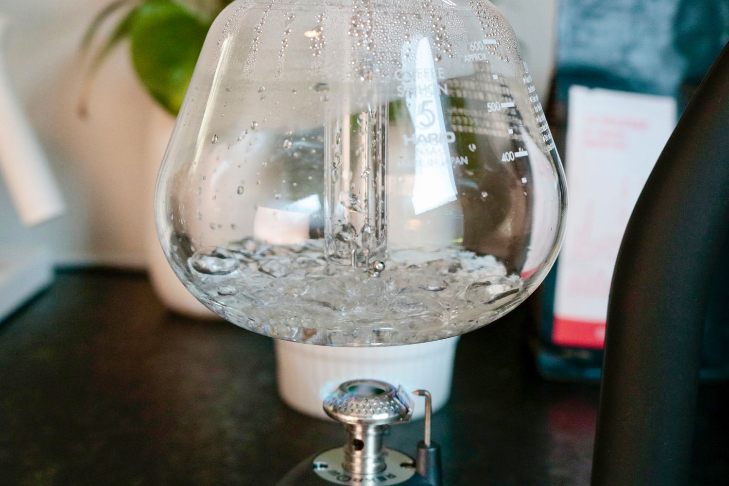 a closeup of a small amount of water boiling in a siphon brewer