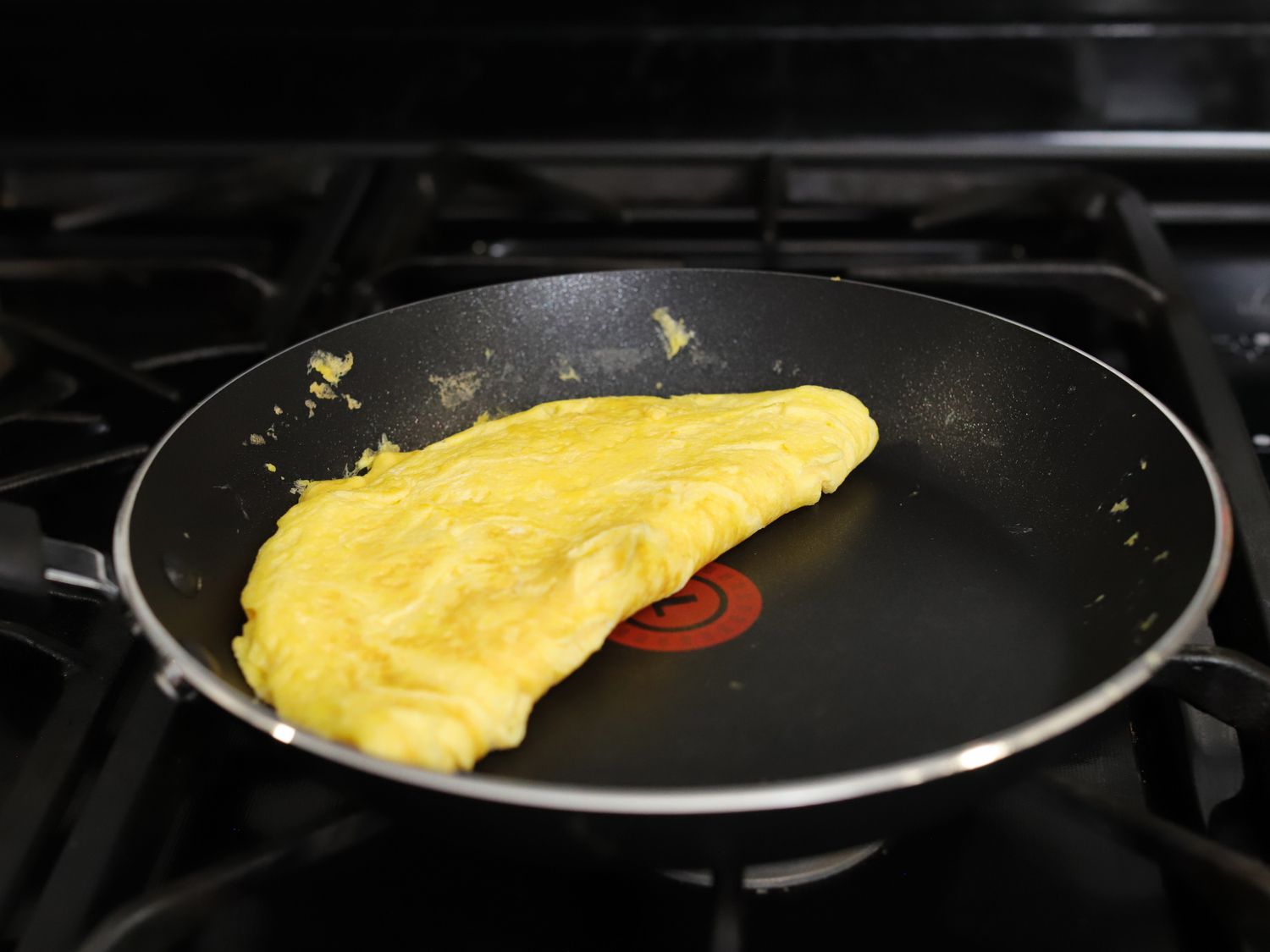A folded omelet sitting in a nonstick skillet