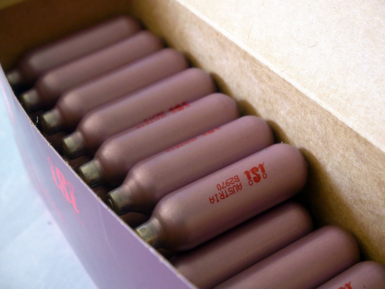 a closeup image of the iSi nitrous oxide cartridges in a box