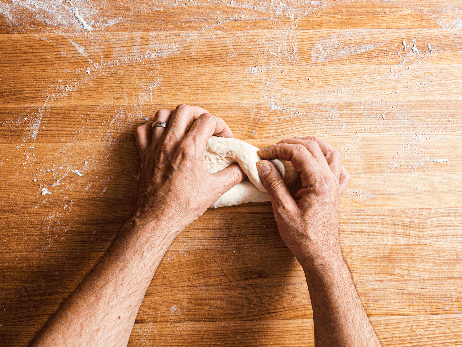 Gif of folding the dough using your thumb into a log