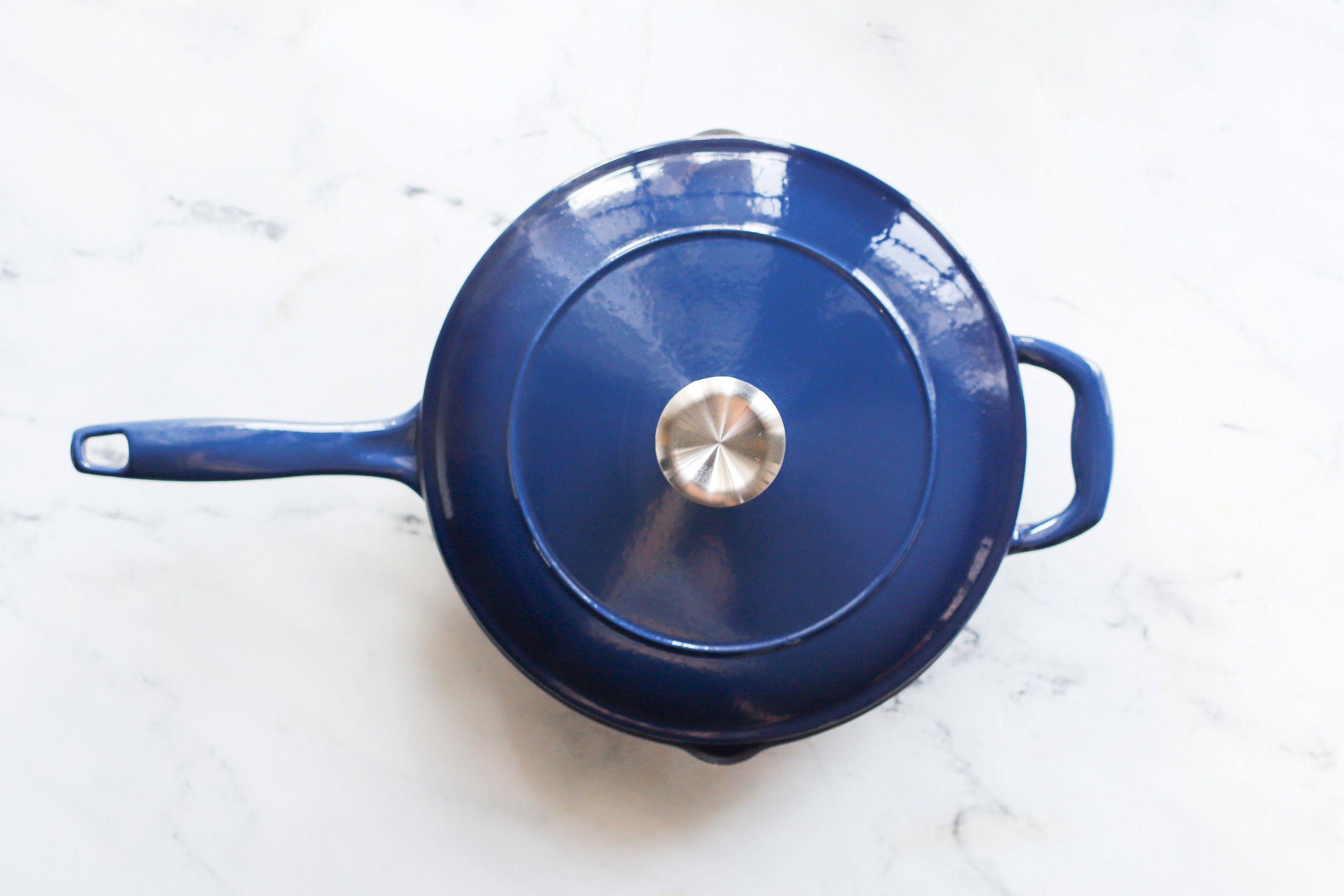 blue skillet on marble countertop