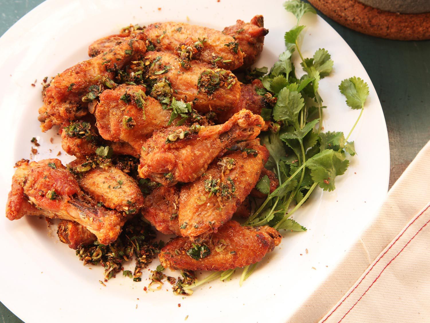A plate of oven-fried chicken wings spiced with chili, cumin, and anise