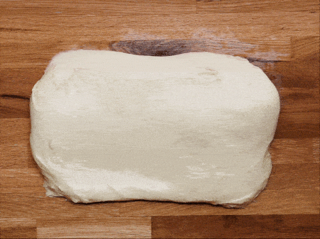 Overhead view of brioche dough getting folding