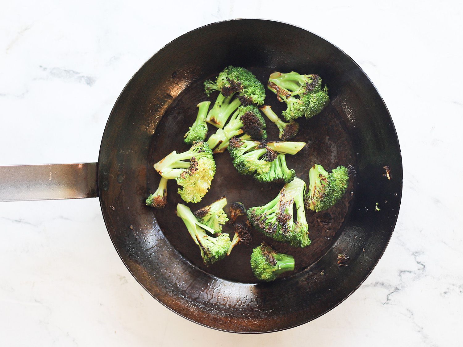 broccoli in a carbon steel skillet