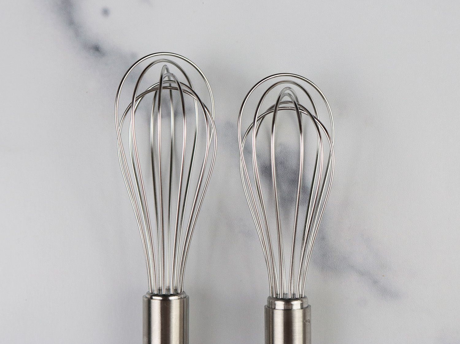 two nearly identical mini whisks
