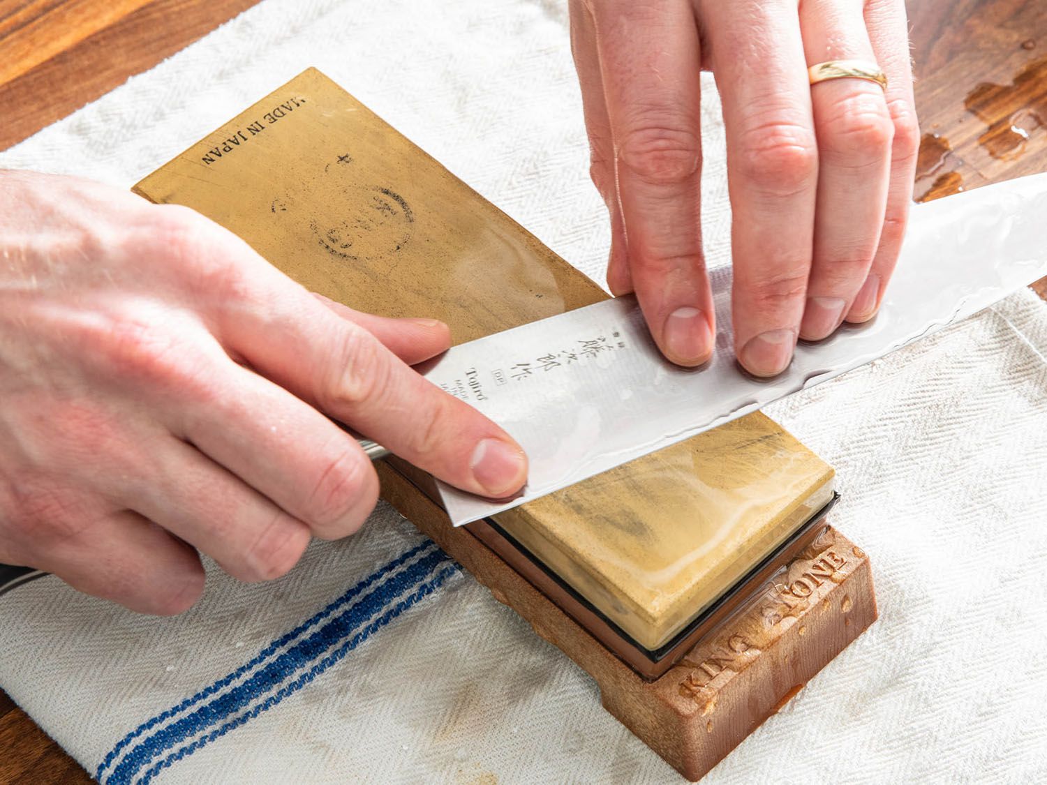 Knife being sharpened on whetstone