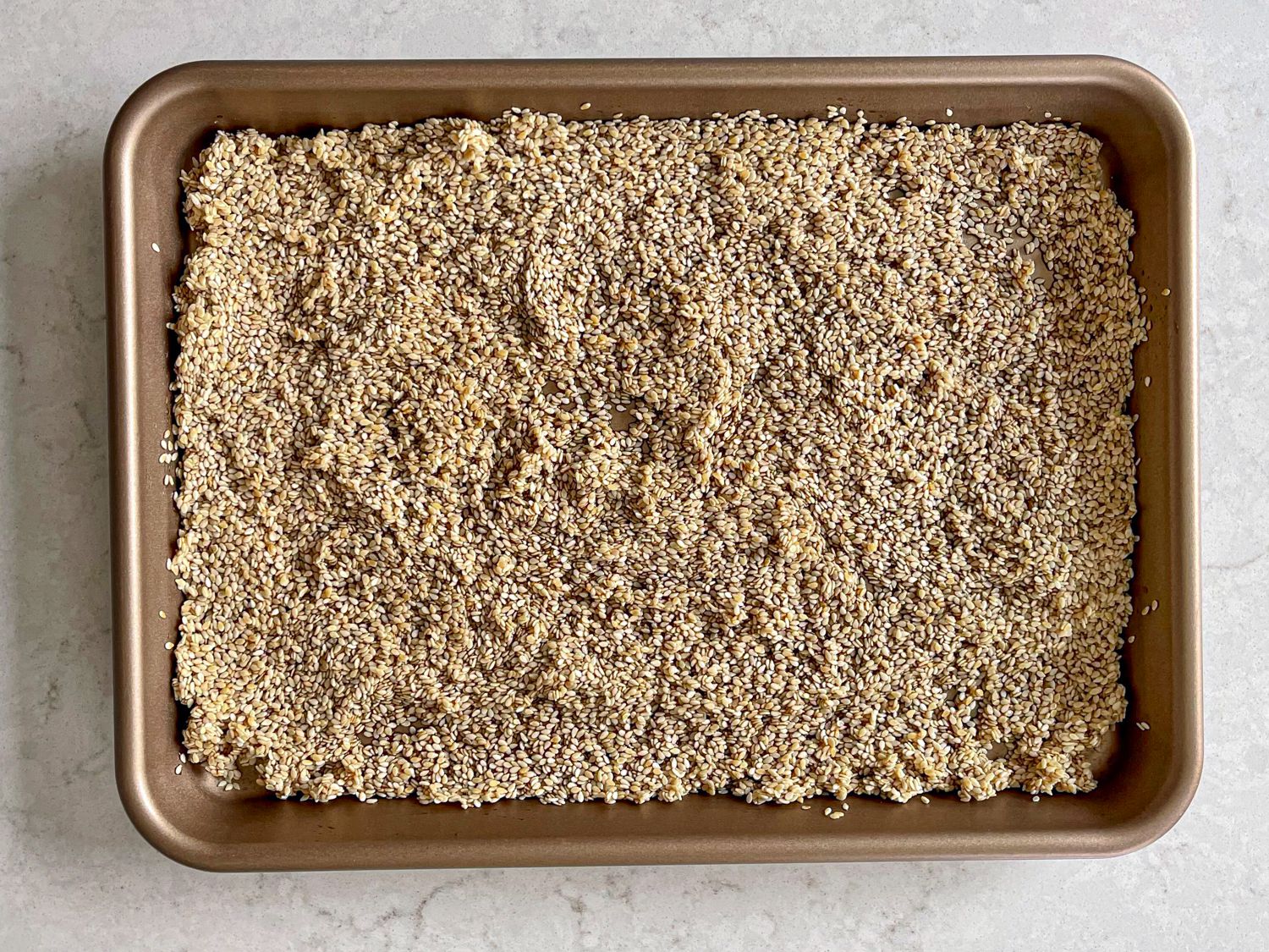 Overhead view of sesame seeds in molasses