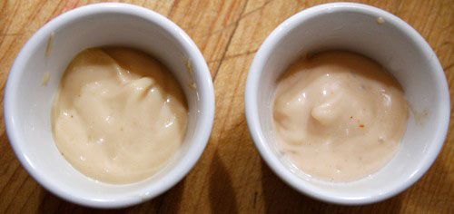 Two white ceramic ramekins holding homemade Shack Sauce and Shack Sauce from a Shake Shack.