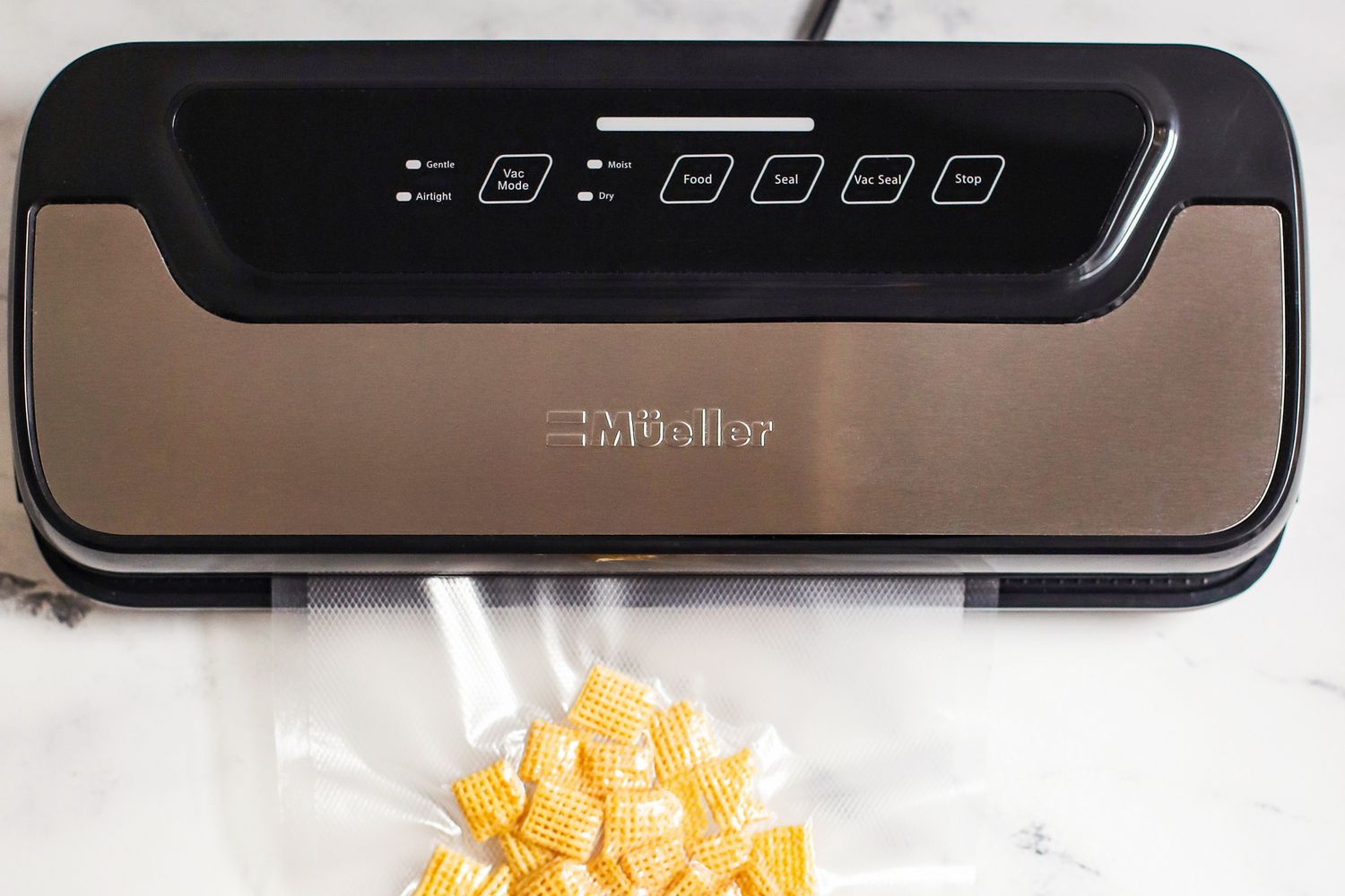 The Mueller vacuum sealer vacuum sealing a bag of Chex