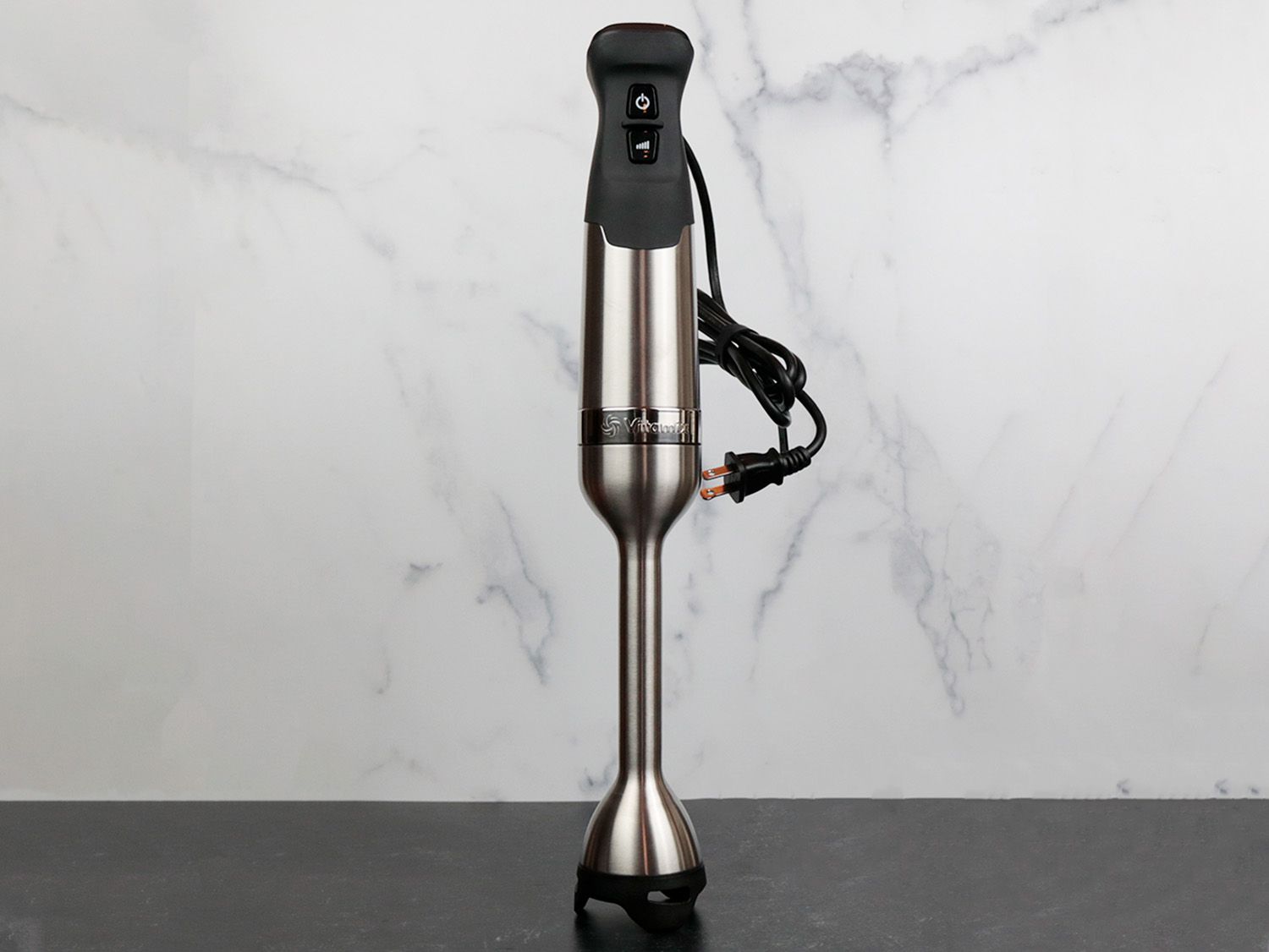 a Vitamix Immersion blender standing upright against a marble backdrop