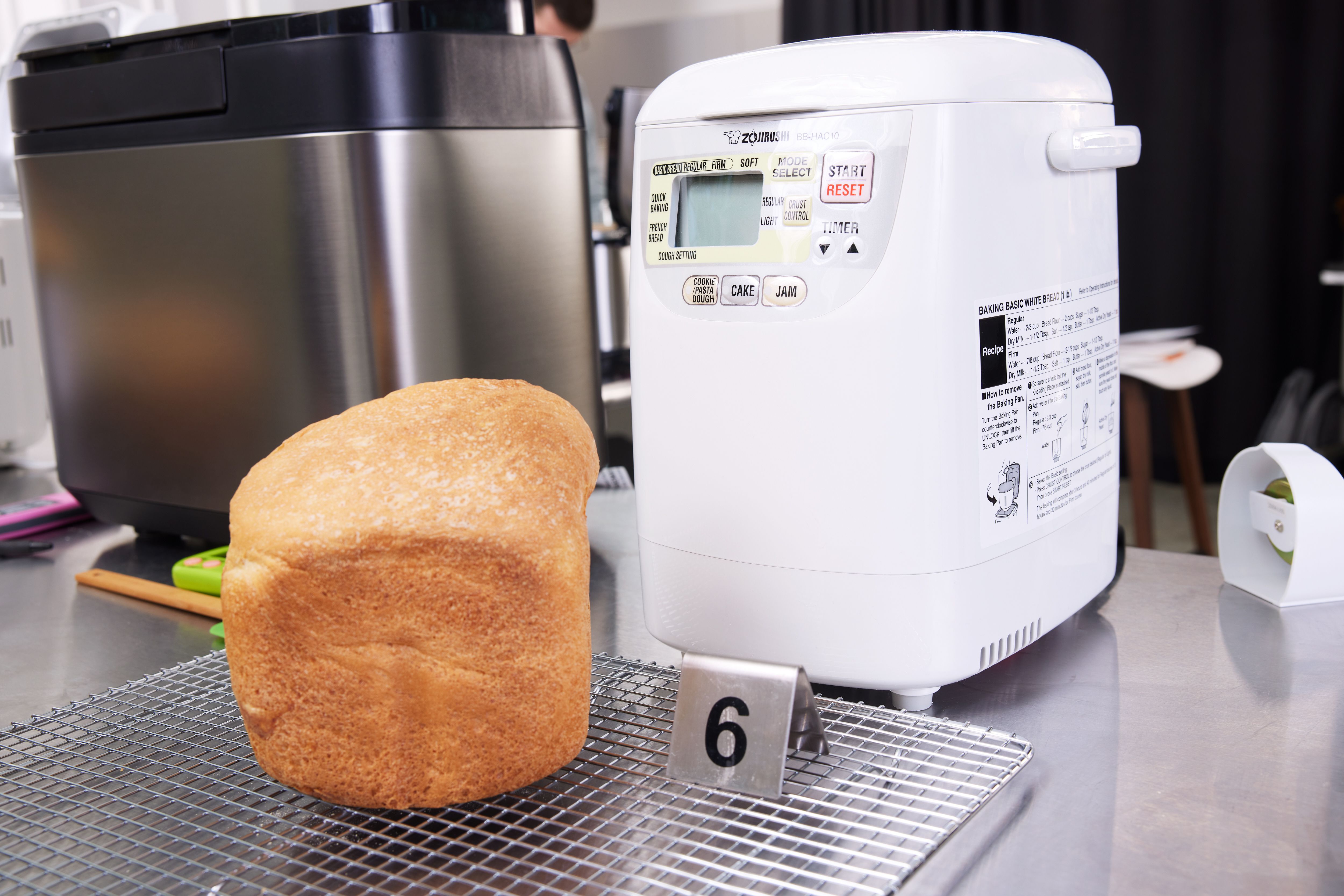 a loaf of bread next to the Zojirushi Home Mini bread machine