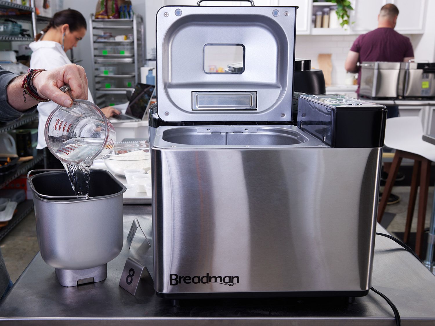 liquid ingredients being added to a bread machine pan